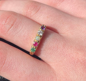 A beautiful 9carat gold gemstone ring signifying ADORE with Amethyst, diamond, opal, ruby and emerald. Antique style adoration. 