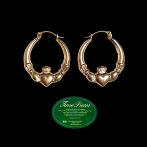 Gold claddagh hoop earrings.